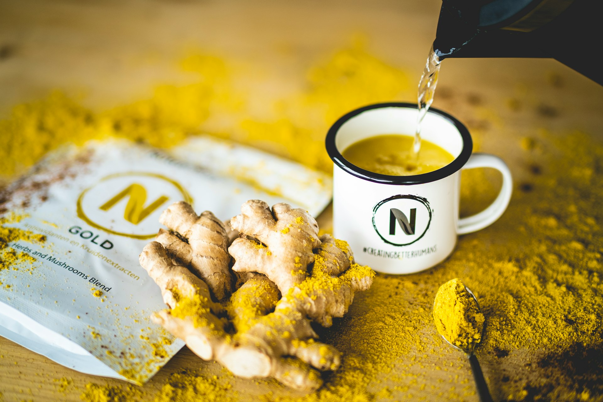 a cup of tea being poured into a bag of ginger